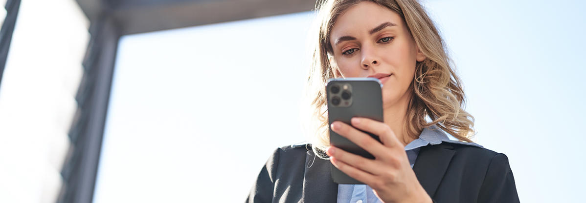 Business woman looking at cell phone