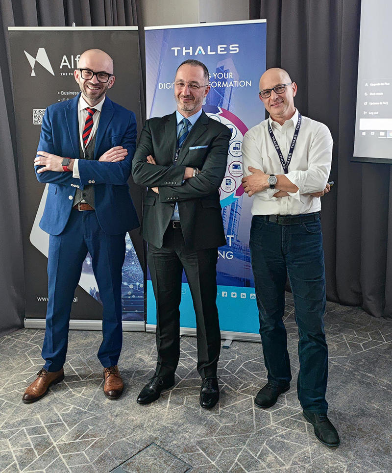 Three business people standing in front of the conference