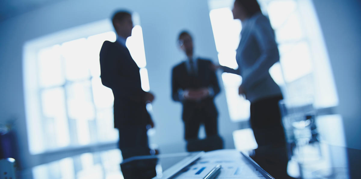 Financial - meeting, people standing in the office, tablet in front