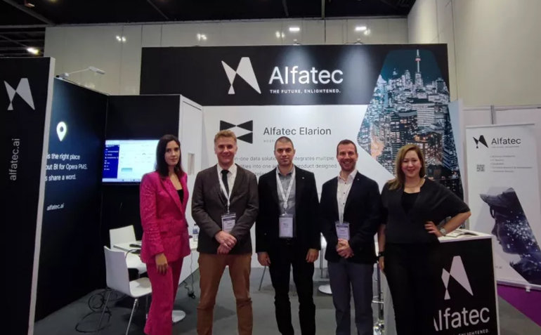 Workers in front of the Alfatec banner